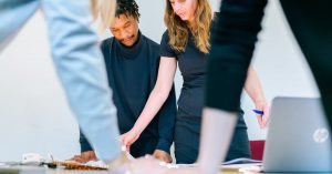 Business professionals engaged in a team meeting in a modern office setting.